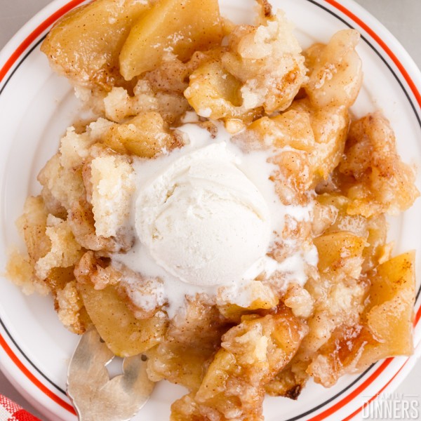 Apple crisp without oats on a plate with ice cream.
