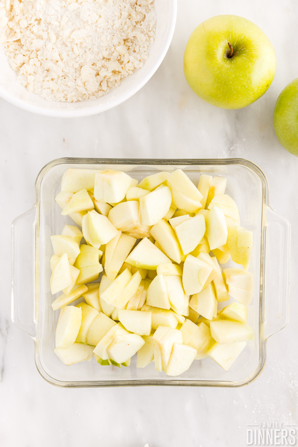 peeled, cored and sliced apples in a baking dish