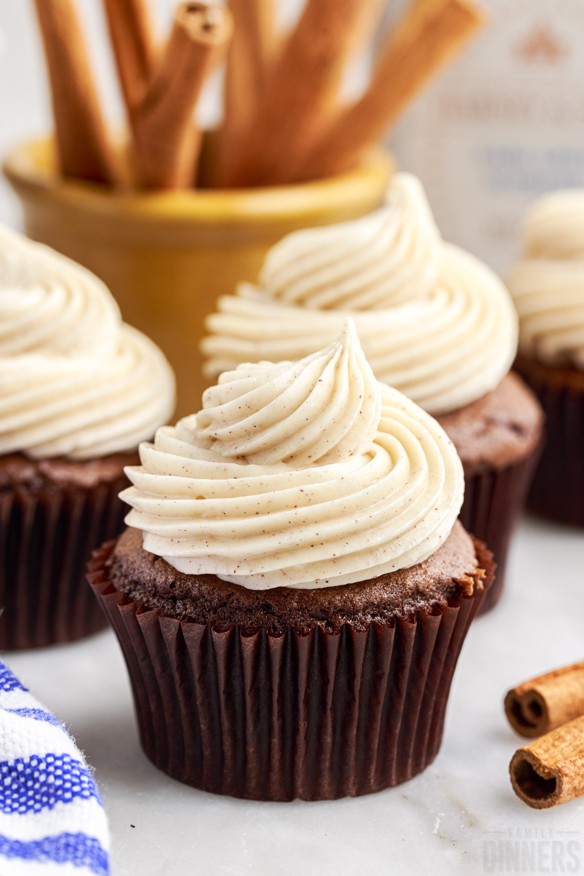 cinnamon cream cheese frosting on chocolate cupcakes