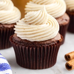 close up of cinnamon cream cheese frosting on a chocolate cupcake