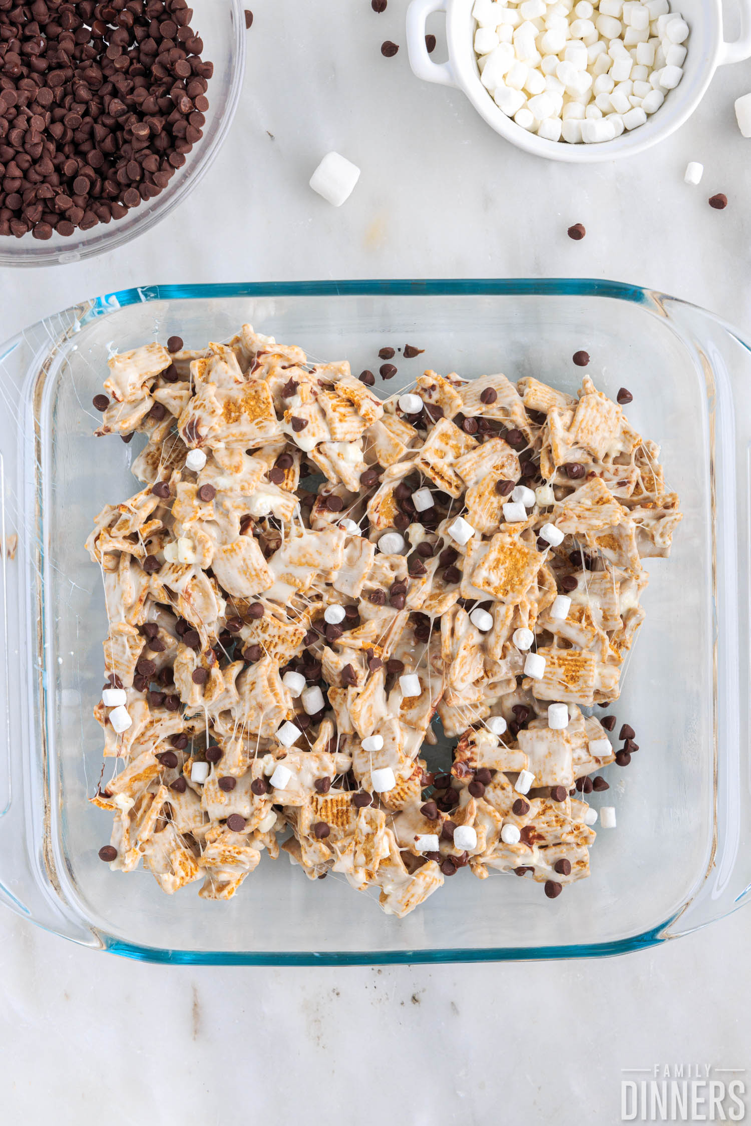 s'more cereal bar mixture pressed into glass baking dish