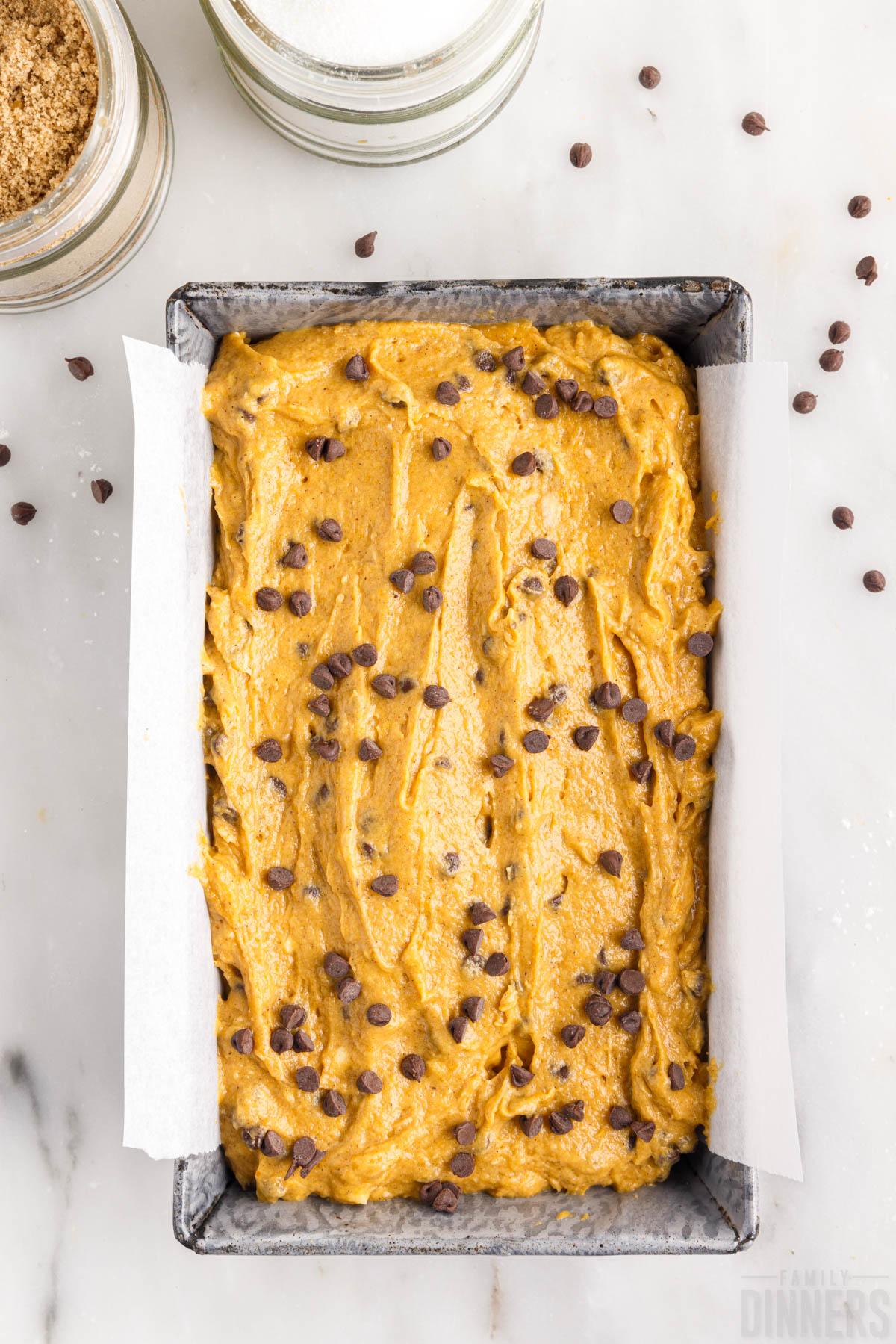 raw pumpkin batter in baking tin topped with chocolate chips