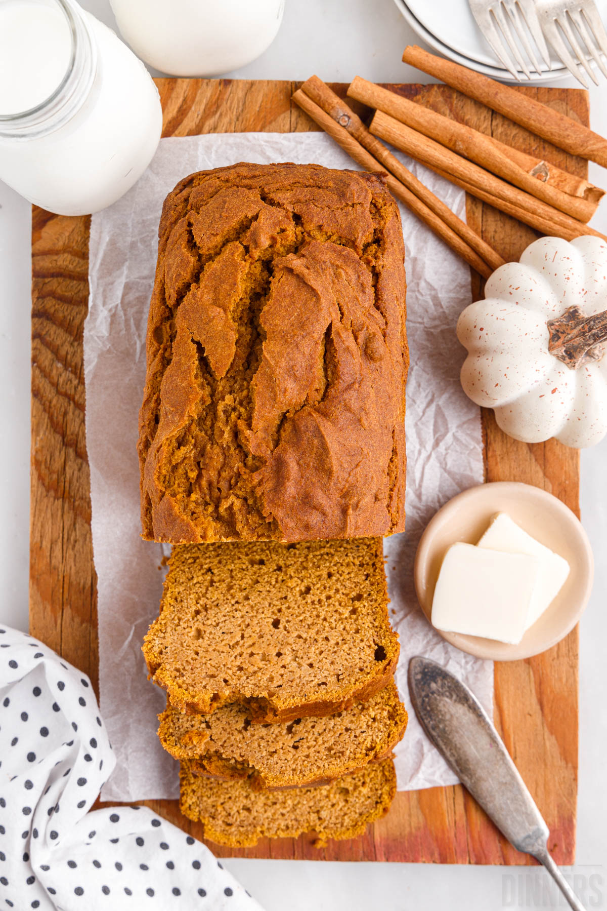 sliced gluten free pumpkin bread with butter and a knife