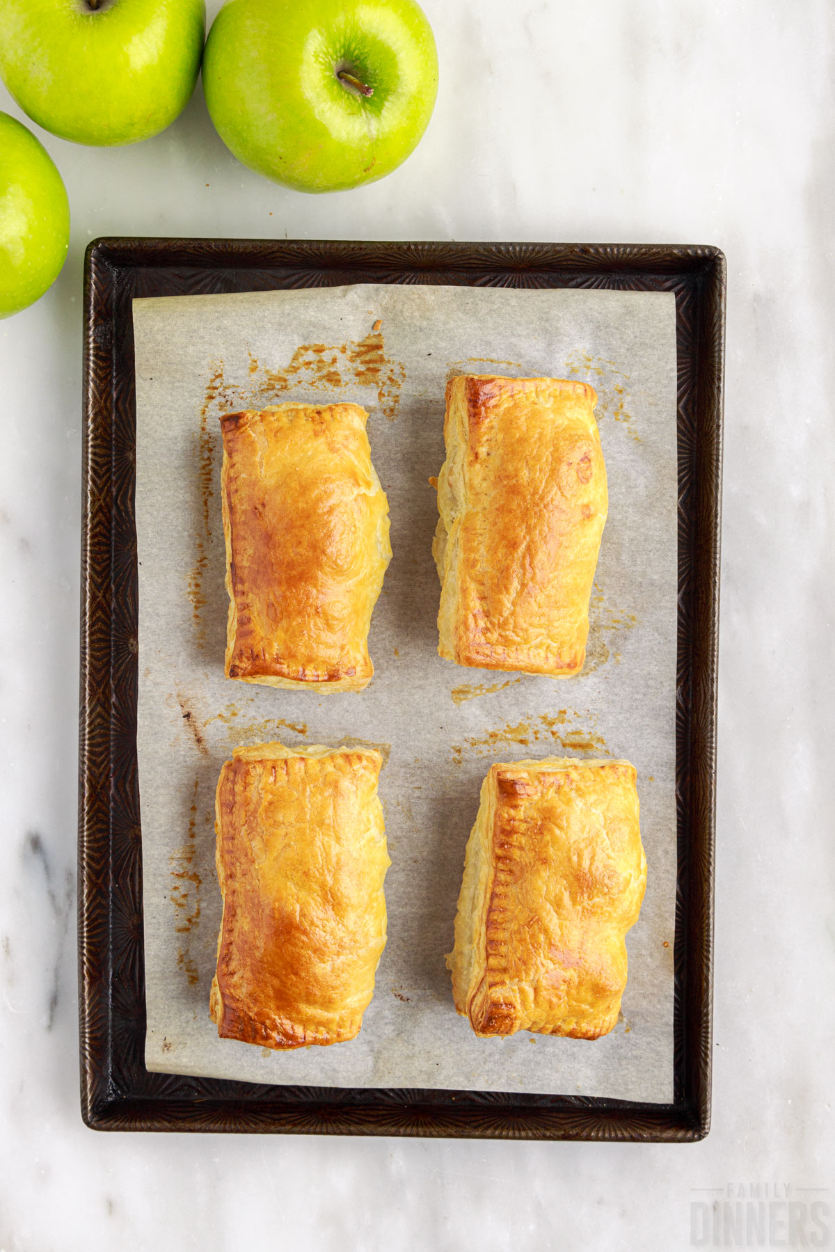 baked apple puff pastries on a baking sheet