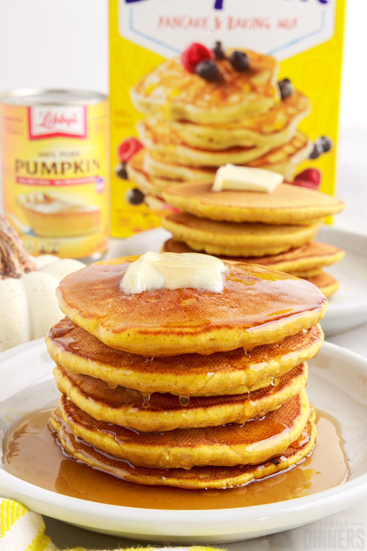 two plates with stacks of pumpkin pancakes with pancake mix