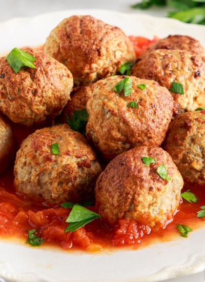 plate of frozen meatballs cooked in the air fryer with marinara