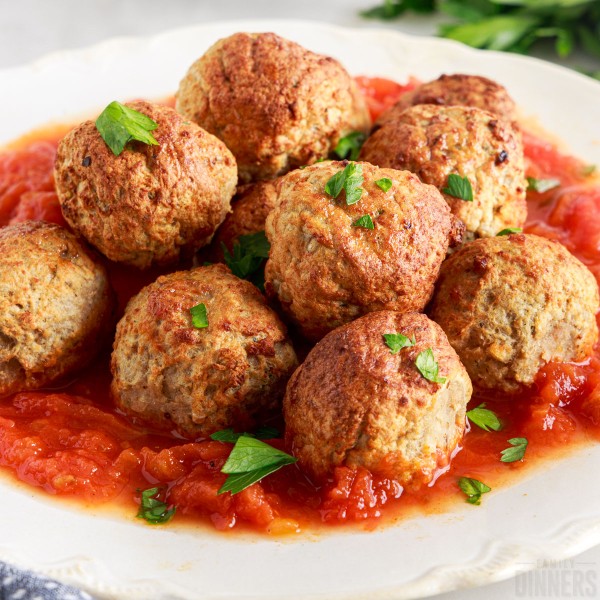 plate of frozen meatballs cooked in the air fryer with marinara