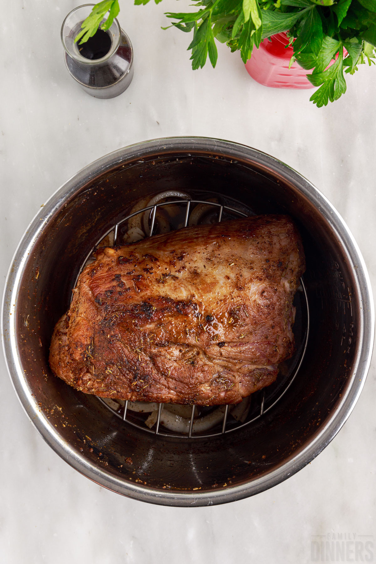 pork roast on metal trivet in instant pot