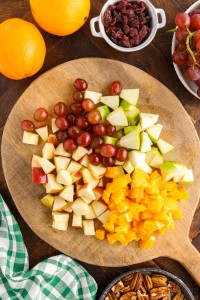 cut up fruit on a wooden board
