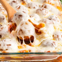 wooden spoon scooping meatball pasta casserole.