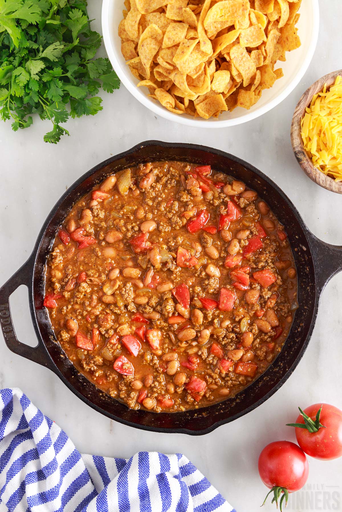 beans and tomatoes added to beef mixture in skillet
