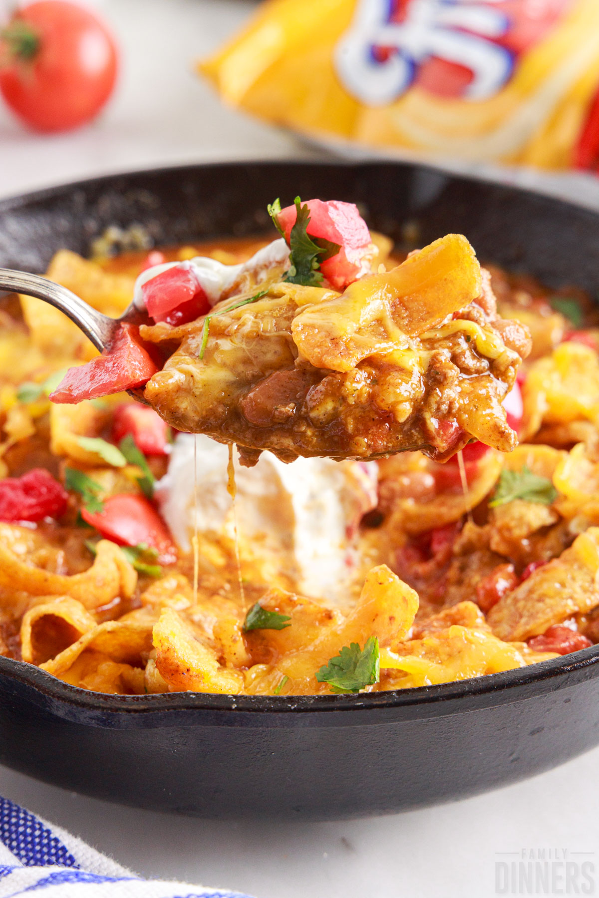 spoon scooping frito pie out of skillet