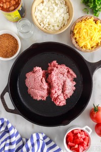 raw ground meat in a skillet