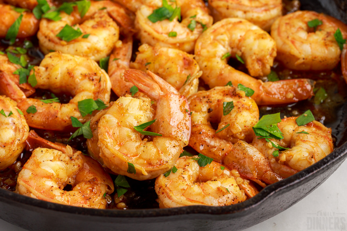 close up of cooked shrimp in a cast iron skillet