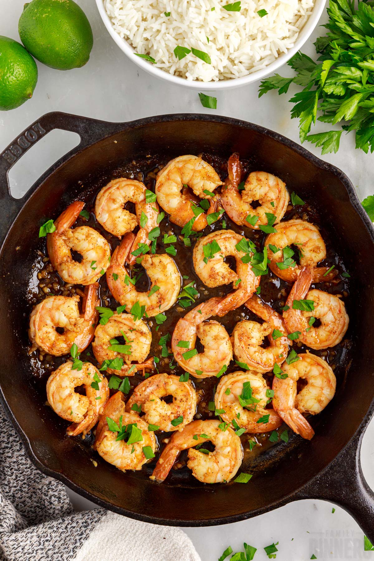 cooked shrimp in a pan sprinkled with parsley