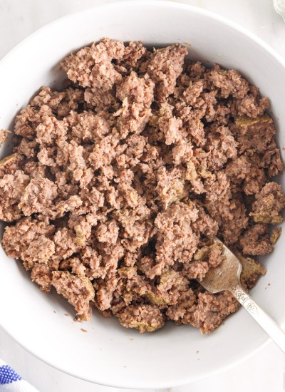 close up of cooked ground beef in a bowl with a spoon