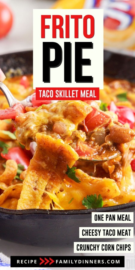 Cheesy taco frito pie casserole with spoon scooping out one scoop.
