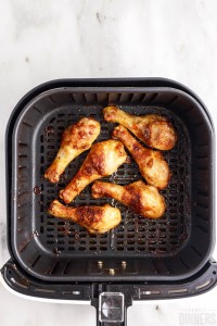 cooked chicken legs in the air fryer basket