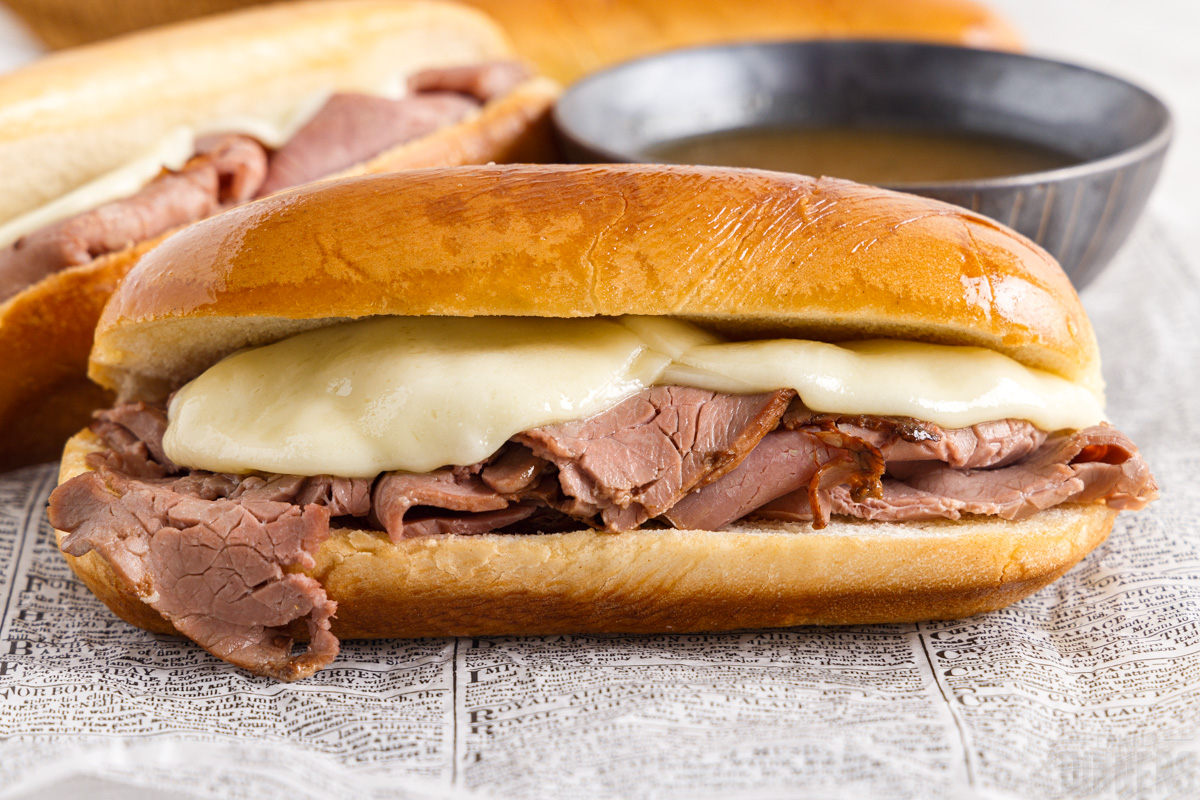 french dip sandwich on a piece of paper with dip