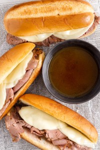 close up of french dip sandwiches with au jus