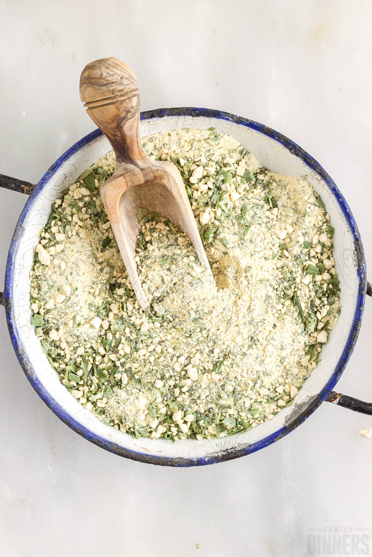mixed up ranch seasoning in a bowl with a wooden spoon