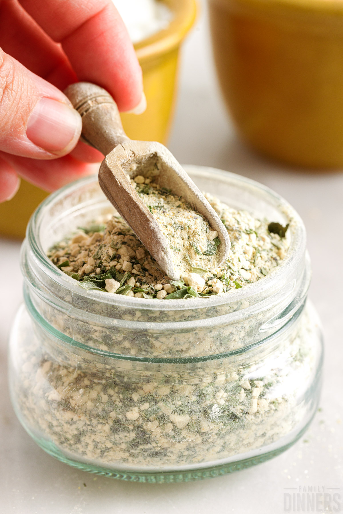 glass jar full of homemade ranch seasoning with wooden spoon