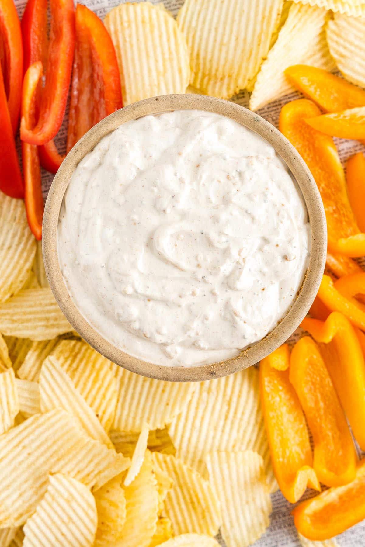 bird's eye view of a bowl of dip with chips and veggies