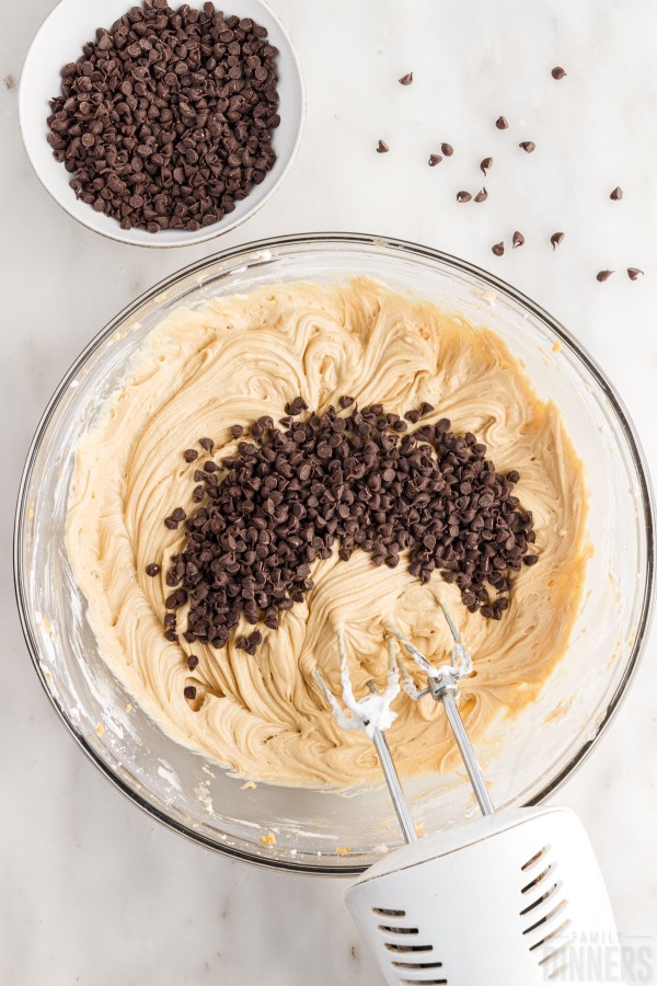 adding chocolate chips to peanut butter dip