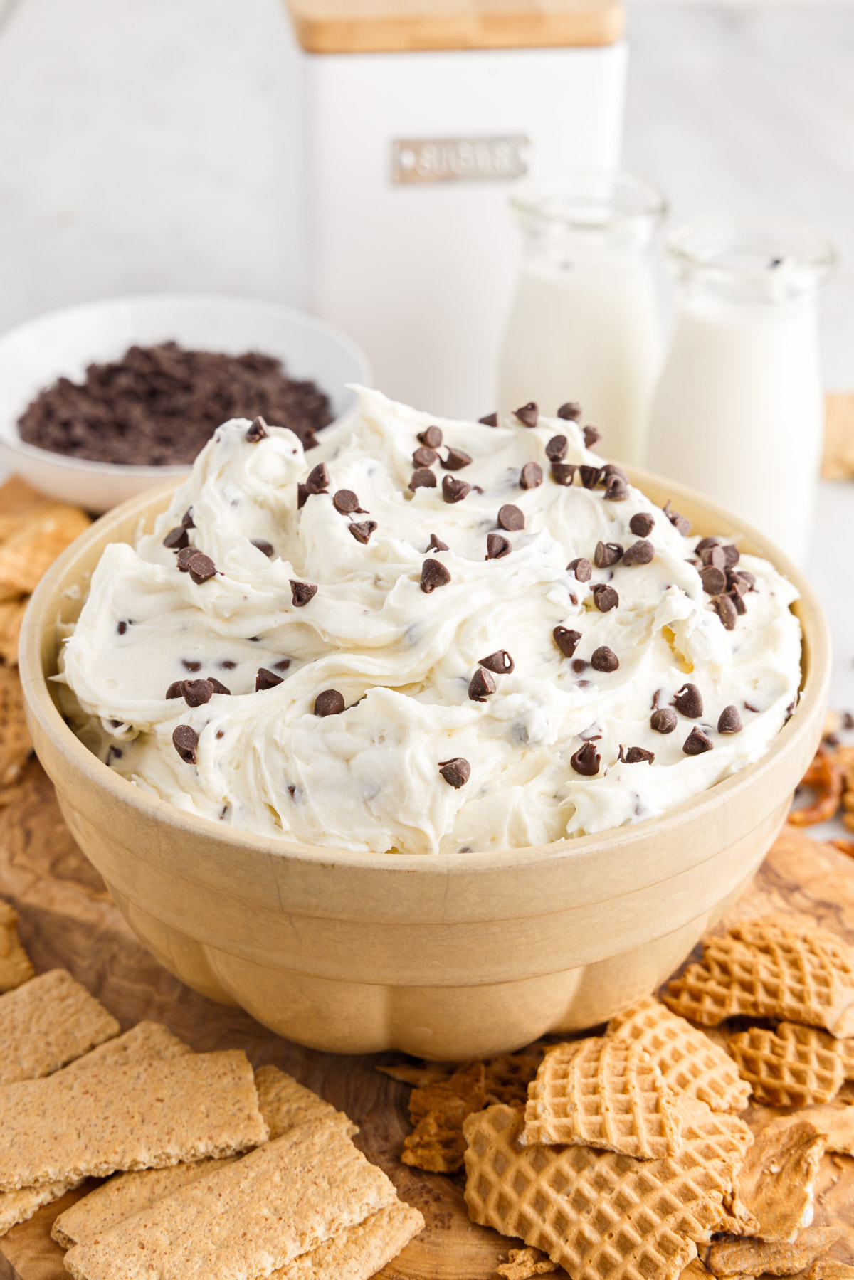bowl of cannoli dip, topped with extra chocolate chips and served with crackers