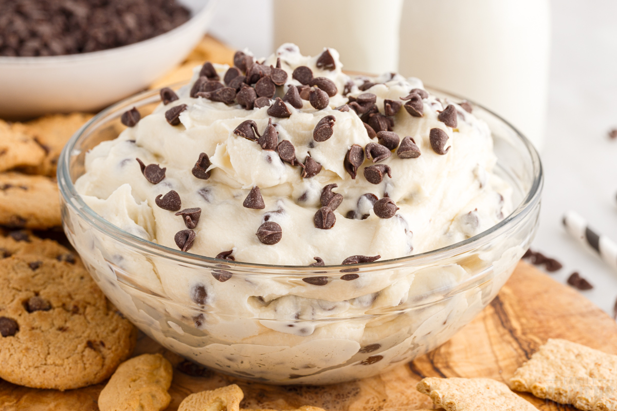 glass bowl full of cookie dough dip topped with chocolate chips
