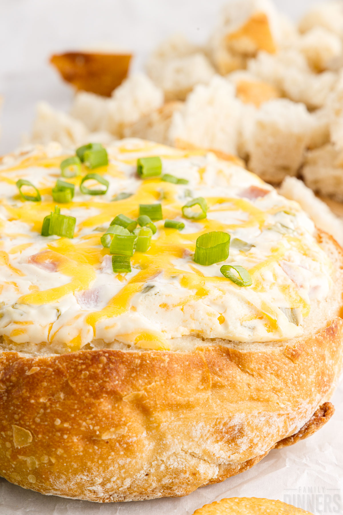 close up of mississippi sin dip in a bread bowl with cubed bread in the background