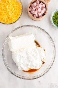 cream cheese, sour cream, hot sauce and Worcestershire sauce in a bowl