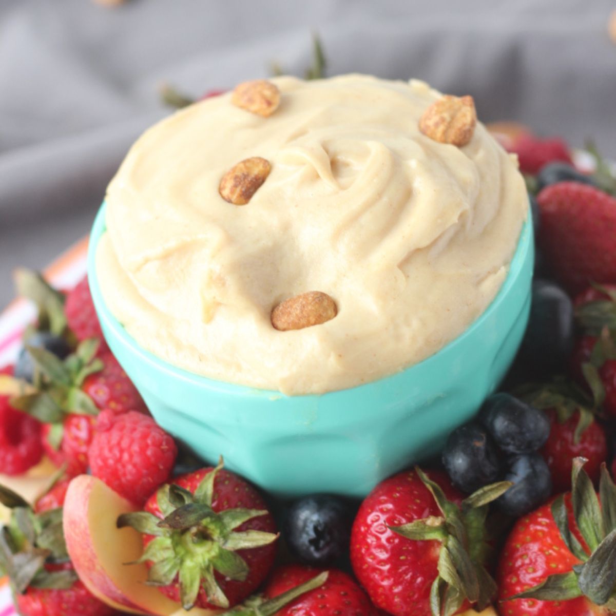 bowl of peanut butter cheesecake dip with fresh fruit