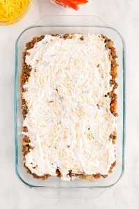 sour cream mixture spread over taco meat layer