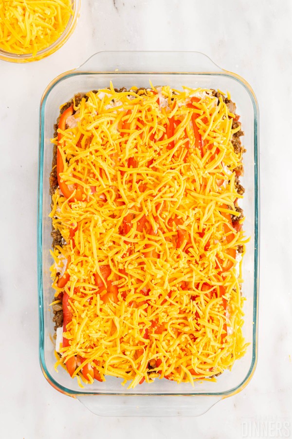 sliced red bell pepper and cheese spread on top of john wayne casserole