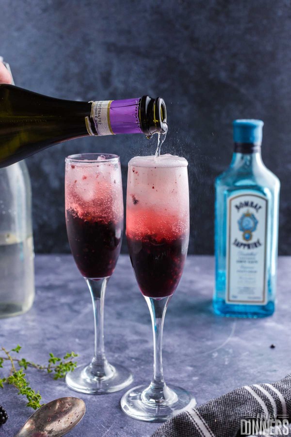 topping blackberry gin cocktails with prosecco